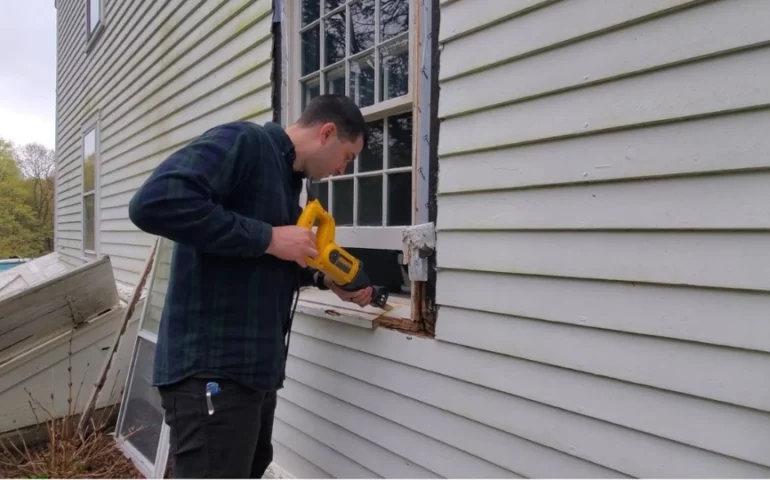 A technician structural joint of a wooden window frame to Professional window repair wood rot in Florida.