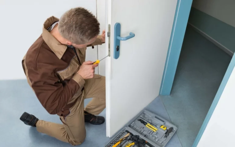 Professional door repairdoor repair services technician installing stainless steel rollers on Florida sliding glass door with ocean view