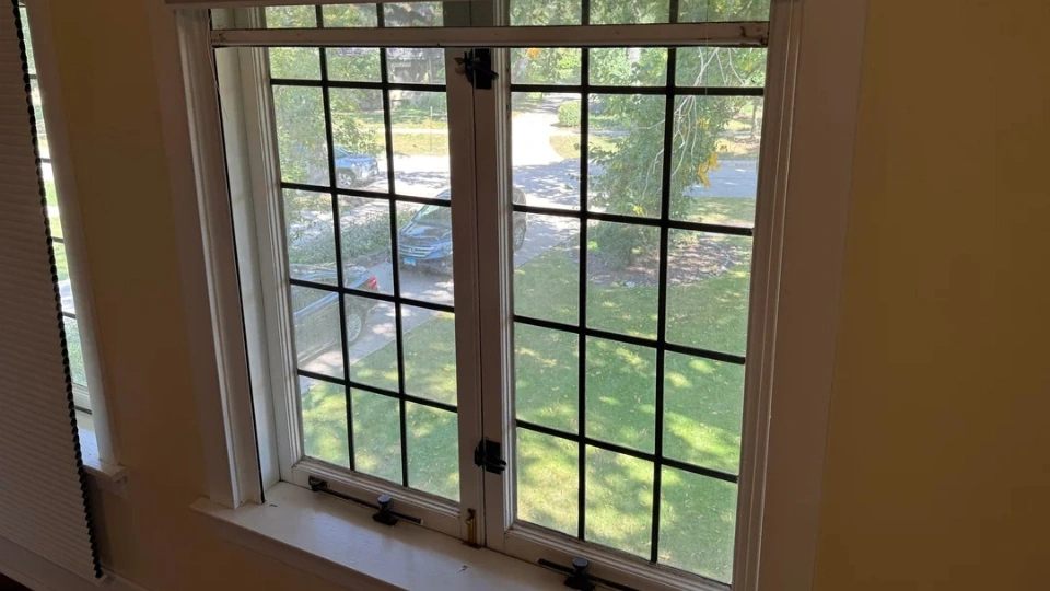 A close-up view of specialized, heavy-duty screen mesh being installed on a sliding glass door frame in Miami FL.