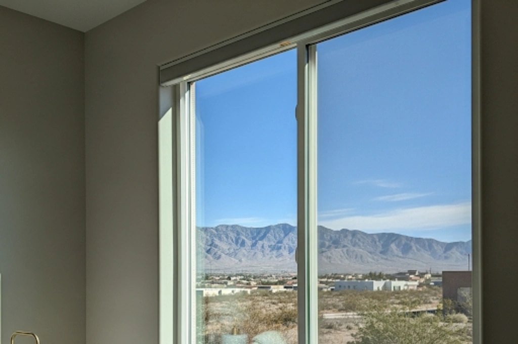 A crystal-clear, newly repaired double-pane window in an florida bedroom, showcasing a perfect view with no fog or condensation.