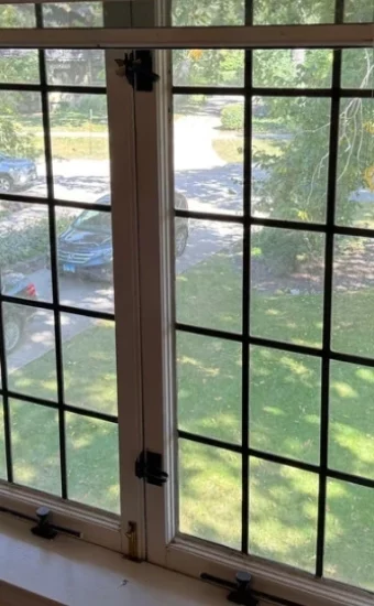 A close-up view of specialized, heavy-duty screen mesh being installed on a sliding glass door frame in Miami FL.