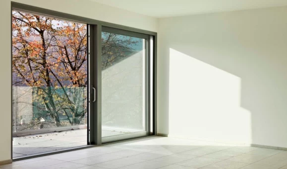 A fully restored sliding glass door repair in Miami, featuring clear glass and a repaired track.