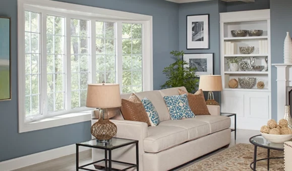 A happy Miami homeowner enjoying a cooler home after a window repair improved insulation.