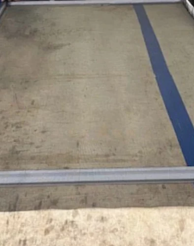 A technician performing a professional window screen repair in Miami with precision tools.